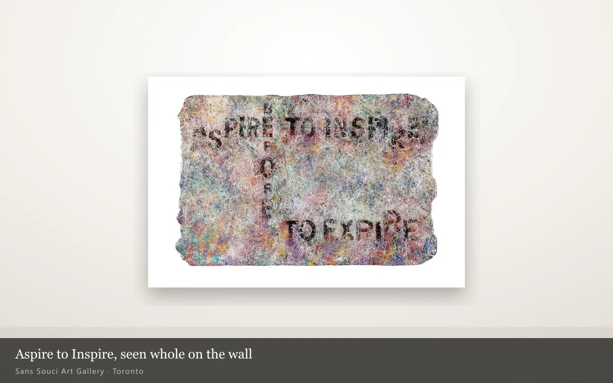 Aspire to Inspire hung whole on a lit gallery wall