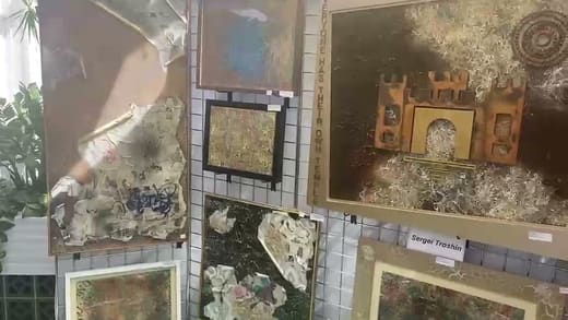 Still from the artist's video: several framed panels on a white grid, one with a castle gate shape in the centre