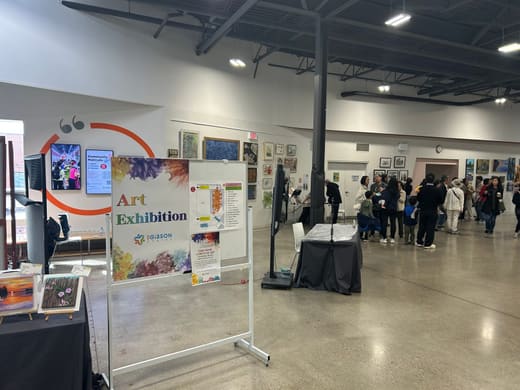 Art Exhibition sign and the 105 Gibson Centre welcome table at the entrance to the hall